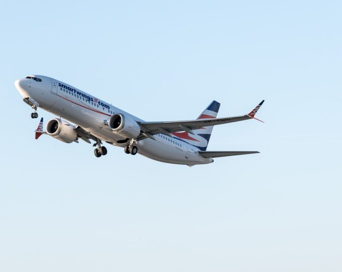 A large jetliner flying through a blue sky