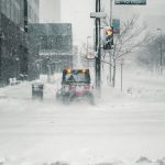black car on snow covered road during daytime