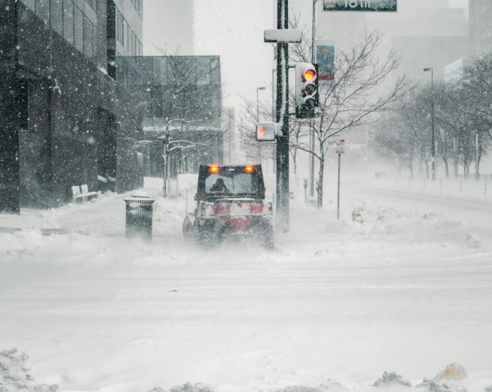 black car on snow covered road during daytime
