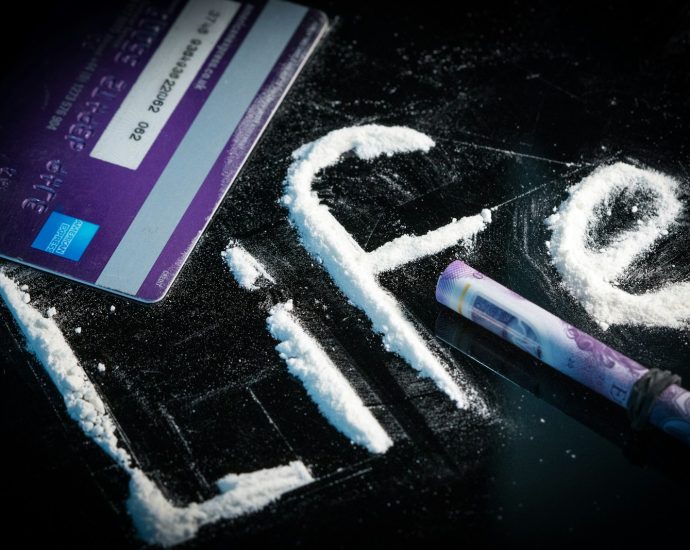 pink and white card on black surface