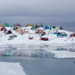view photography of assorted-color houses near pond during daytime