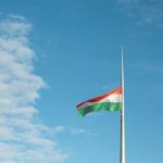 a flag is flying high in the sky