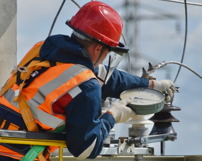 man in blue orange and white jacket wearing red helmet