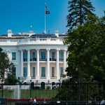 a large white building with a flag on top of it