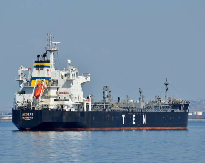 black and white ship on sea under gray sky during daytime