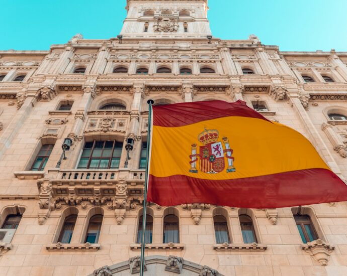 flag on pole beside building during day