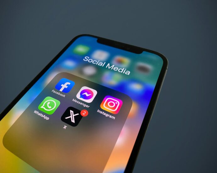 a close up of a cell phone with social media icons