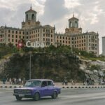 purple sedan on road near building during day