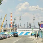 a road with cars and a building with a tower in the background