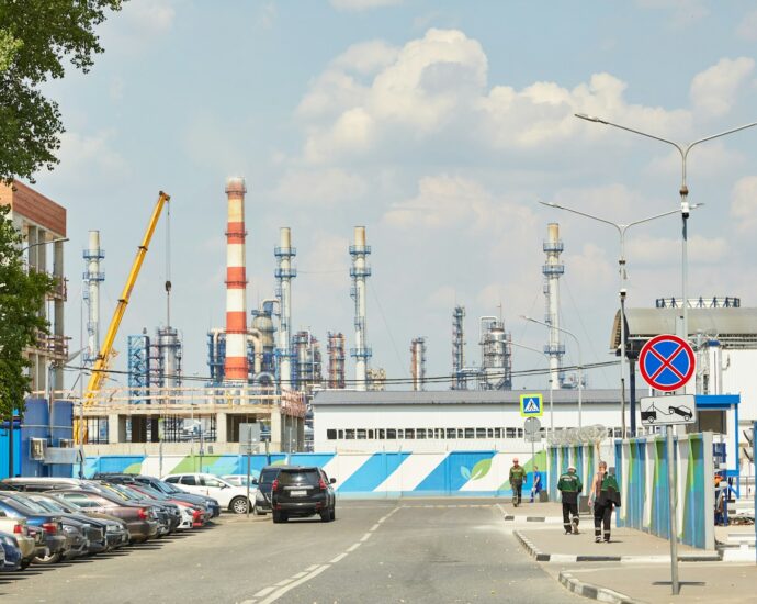 a road with cars and a building with a tower in the background