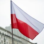 The polish flag waves in the breeze.