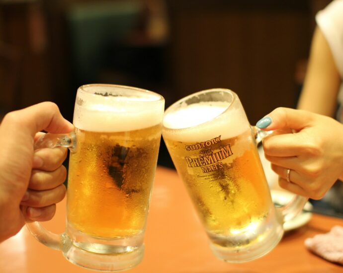 two mugs of brown liquids