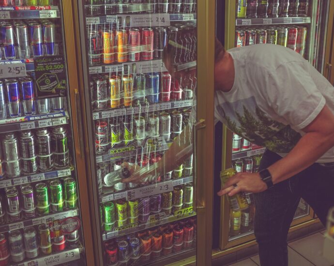 man getting can in beverage cooler
