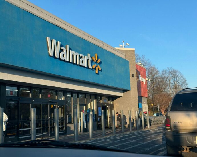 a walmart store with a car parked in front of it