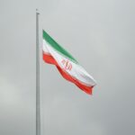 A flag flying in the wind on a cloudy day