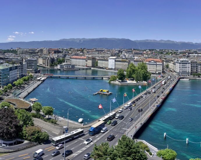 aerial view of city buildings near body of water during daytime