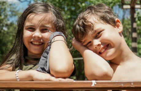 girl in gray sleeveless shirt smiling beside girl in gray sleeveless shirt