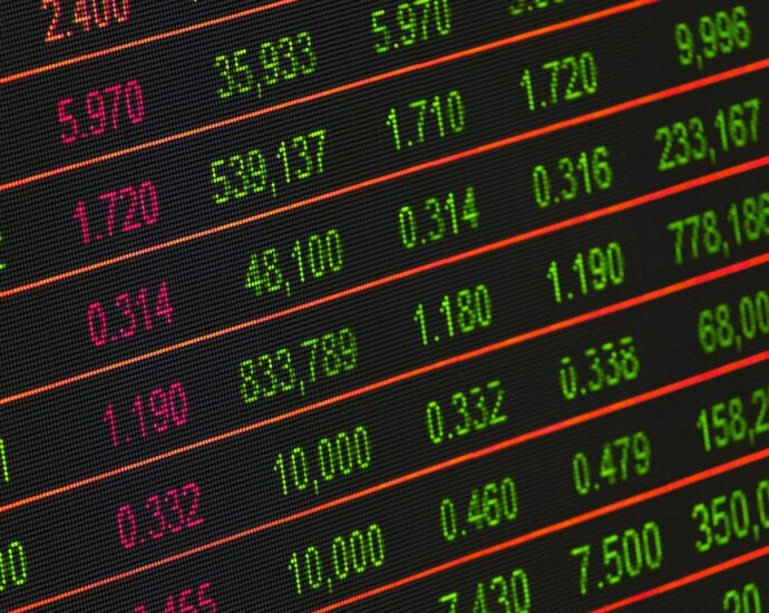 Close-up of a digital stock market data display showing colorful financial numbers and trends.