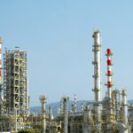 A factory with a lot of red and white pipes