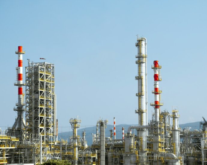 A factory with a lot of red and white pipes