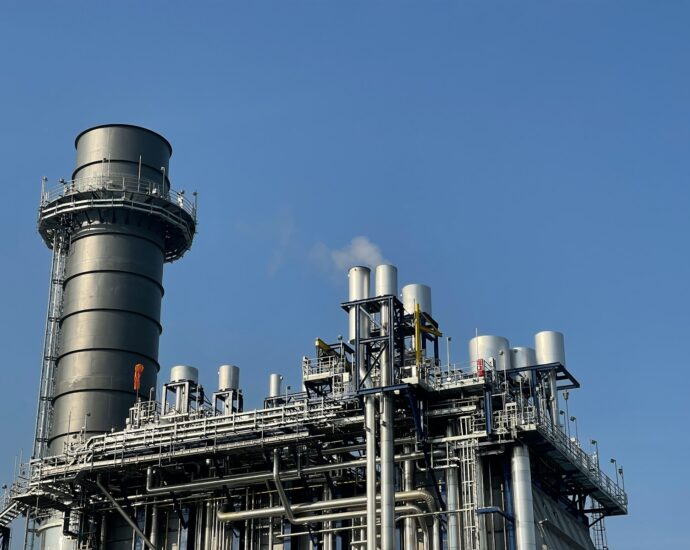 gray and black factory under blue sky during daytime