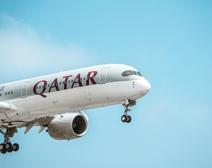a large jetliner flying through a blue sky