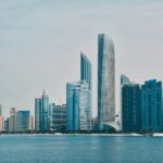 a city skyline with a body of water in the foreground