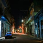 a car parked on the side of a street at night