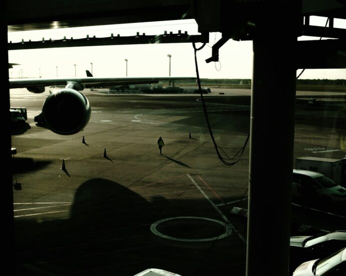 a group of people walking on a wet runway