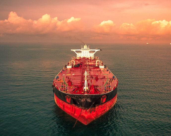 red and white ship on sea under cloudy sky during daytime