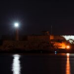 a large castle lit up at night with lights on
