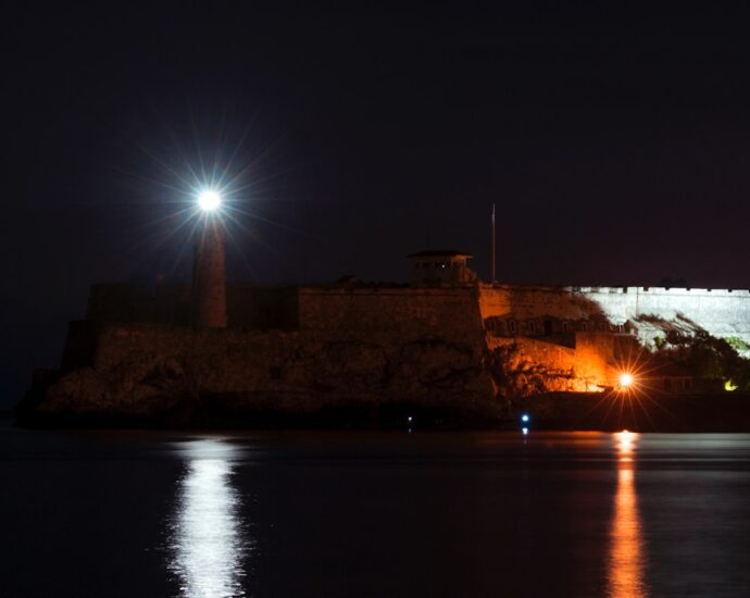 a large castle lit up at night with lights on
