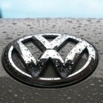 water dew on silver Volkswagen car emblem