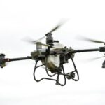 High-resolution image of a specialized agricultural drone flying outdoors, showcasing modern farming technology.