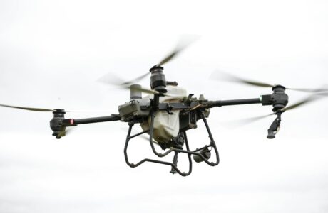 High-resolution image of a specialized agricultural drone flying outdoors, showcasing modern farming technology.