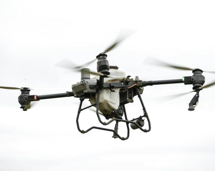 High-resolution image of a specialized agricultural drone flying outdoors, showcasing modern farming technology.