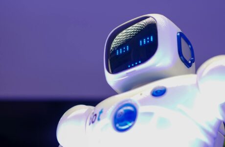 A modern humanoid robot with digital face and luminescent screen, symbolizing innovation in technology.