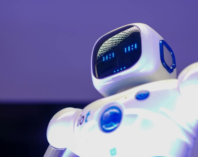 A modern humanoid robot with digital face and luminescent screen, symbolizing innovation in technology.