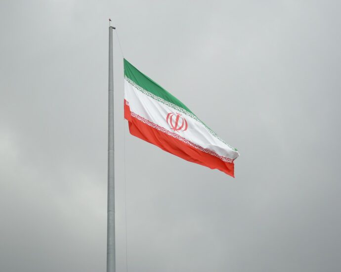 A flag flying in the wind on a cloudy day