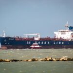 a large cargo ship in the middle of the ocean