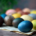 blue yellow and red egg on brown wooden tray