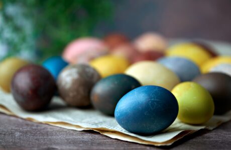blue yellow and red egg on brown wooden tray