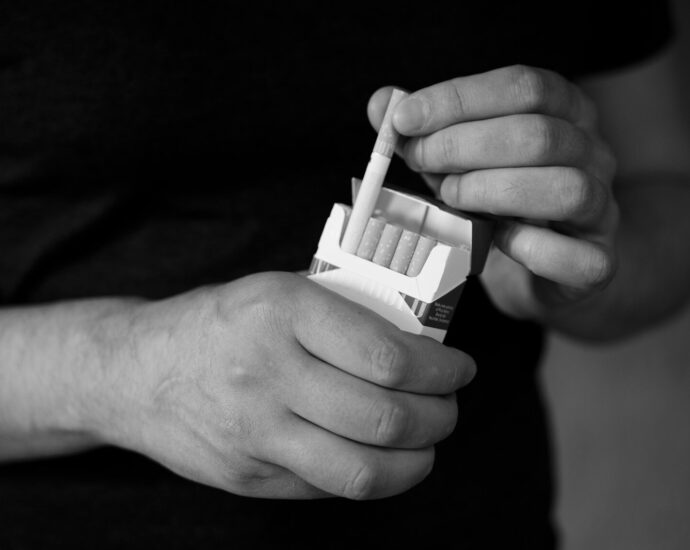 a person holding a cigarette lighter in their hand