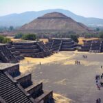 a group of people standing in front of a pyramid