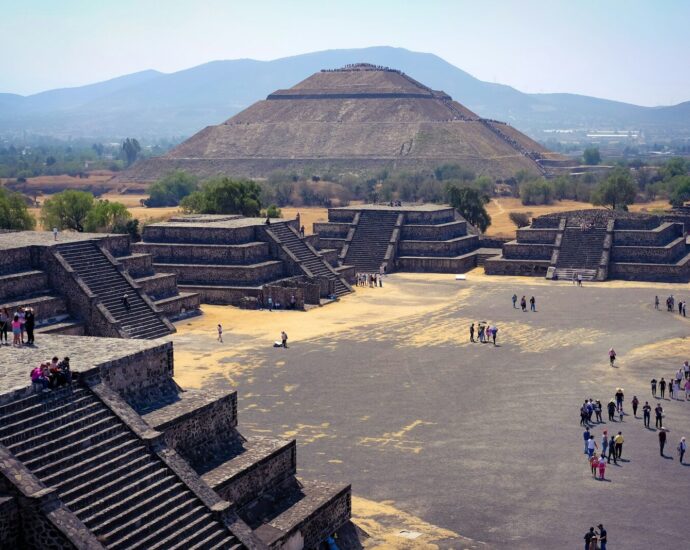 a group of people standing in front of a pyramid