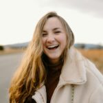 smiling woman in green jacket