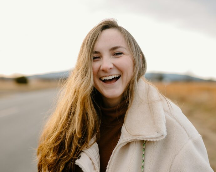 smiling woman in green jacket