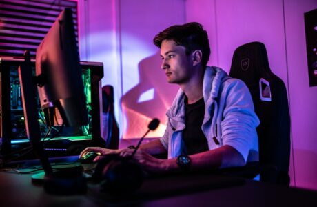 a man sitting in front of a computer monitor