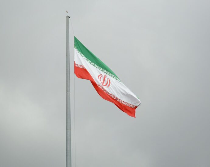 A flag flying in the wind on a cloudy day
