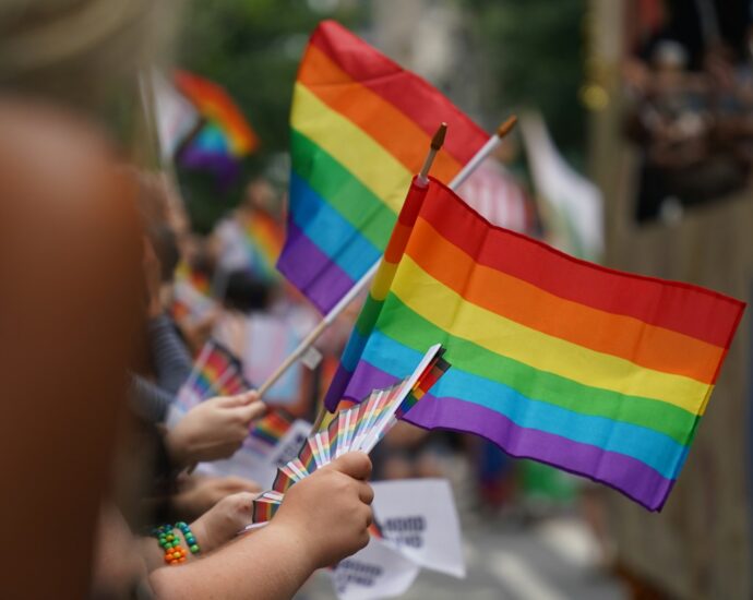 A group of people holding a rainbow flag